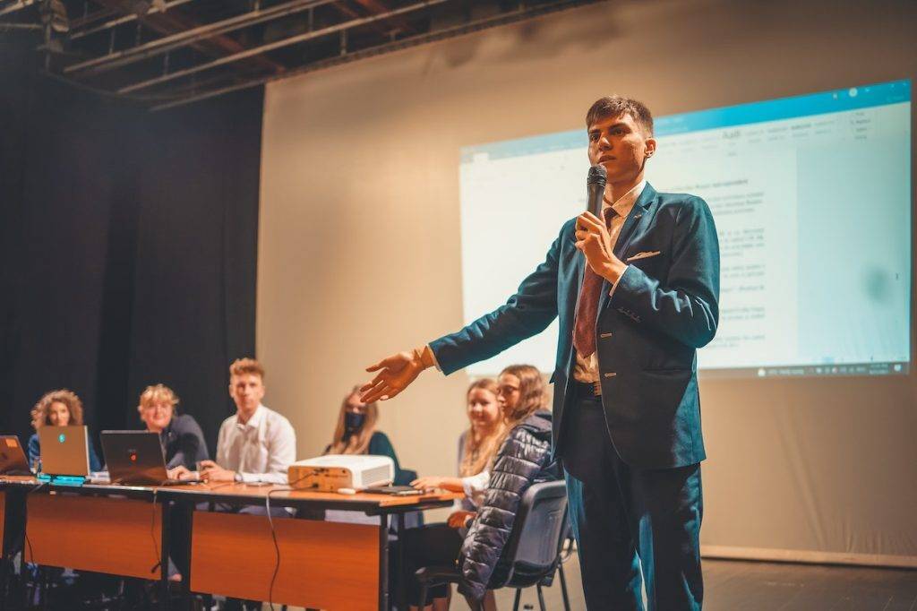 young man presenting on a stage